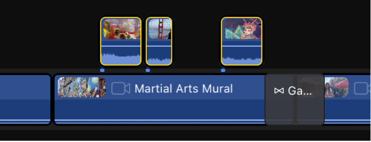 Los clips conectados seleccionados aparecen encima de la pista principal en la línea de tiempo.