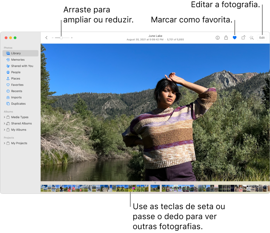 A janela de Fotografias que mostra uma fotografia ampliada à direita e uma linha de miniaturas por baixo. A barra de ferramentas na parte superior inclui o nivelador de ampliação, o botão Favorito e o botão Editar.
