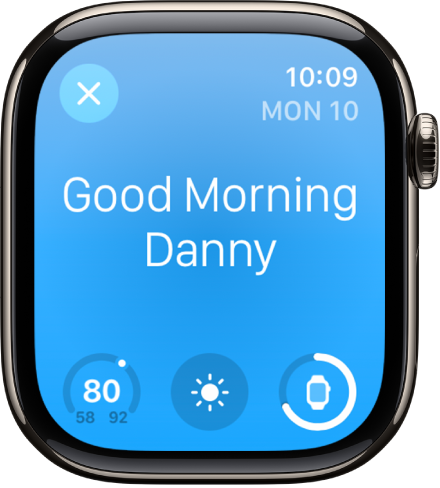 Apple Watch mostrando la pantalla del despertador. Las palabras Buenos días se muestran en la parte superior. Debajo se muestran la temperatura, el estado del clima y el nivel de batería.