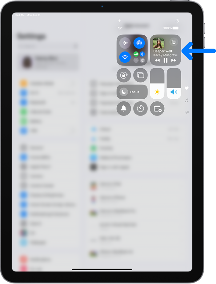 The iPad Control Center showing an arrow pointing to the audio card where you can control music from the Lock Screen or when using another app.