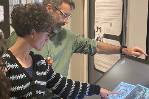 Woman and man looking at interactive screen