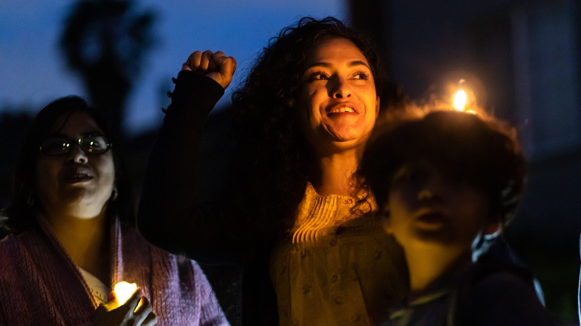 Ruby Gordillo speaks during a candlelight prayer rally outside the “reclaimed” home on Sunday evening. (Brian Feinzimer)