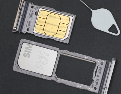 Close-up of a SIM card tray alongside a dual slot SIM card while next to a SIM ejector tool