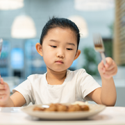 Girl looking at food without appetite