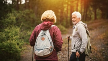 Older couple walking in a forest