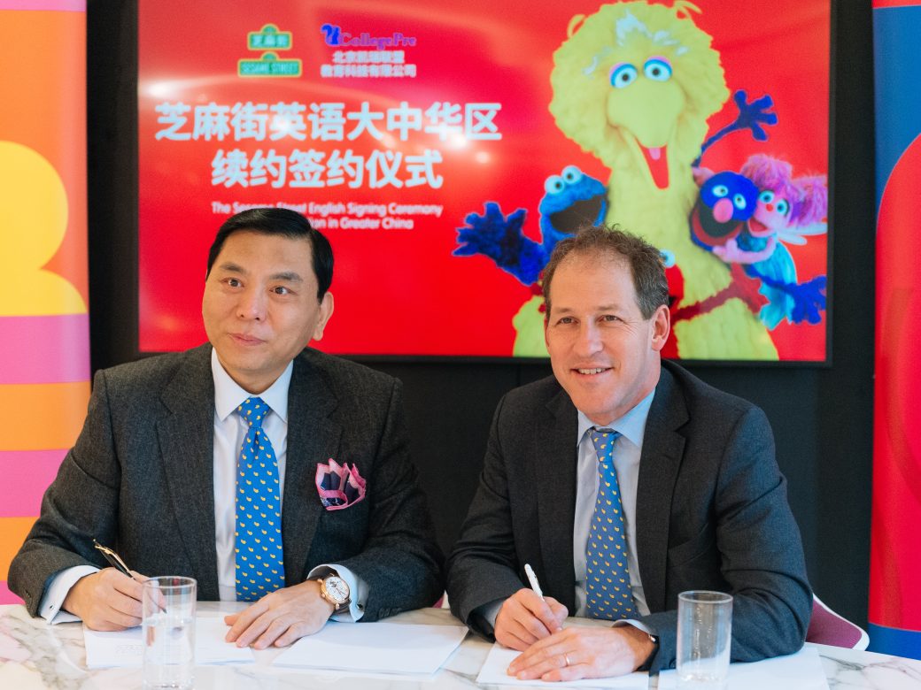 Steve Youngwood signs an agreement with a representative of Beijing Kairui