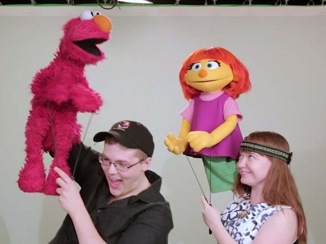 Ryan Dillon puppeteering Elmo, and Stacey Gordan puppeteering Julia.