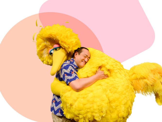 Big Bird and Alan hugging.