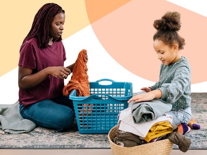 A child and caregiver are folding clothes.