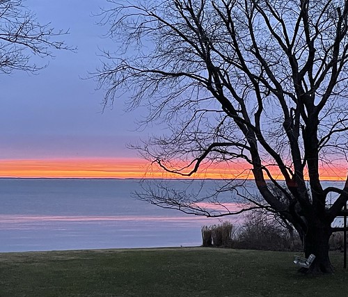 Photo of pre-dawn sky over the bay from a shoreline in winter