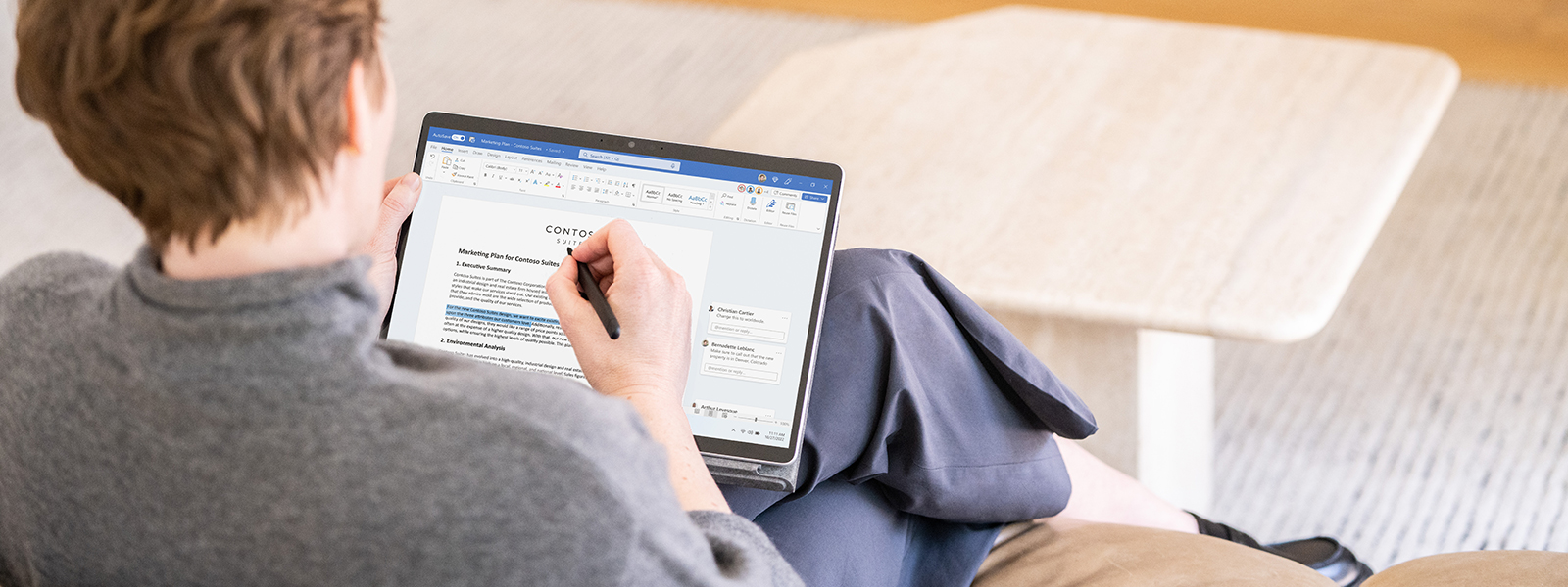 A person on a couch taking notes for a marketing strategy.