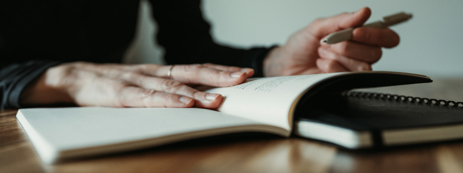 A woman sitting at a table with a notebook