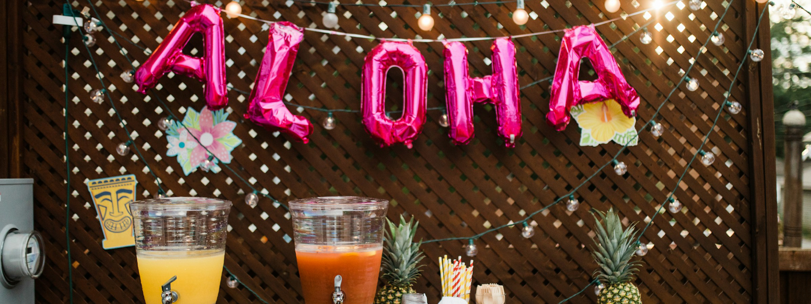 Festive table with “Aloha” balloons in the background