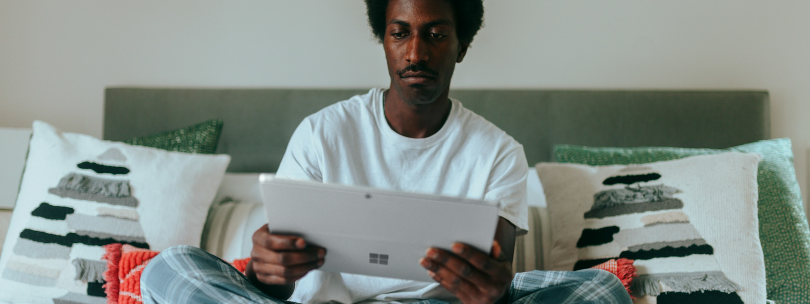 Man on bed with laptop