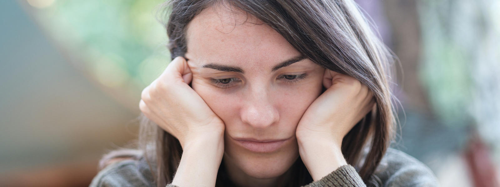 Woman holding her head in her hands