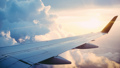 View of an airplane wing from inside the plane