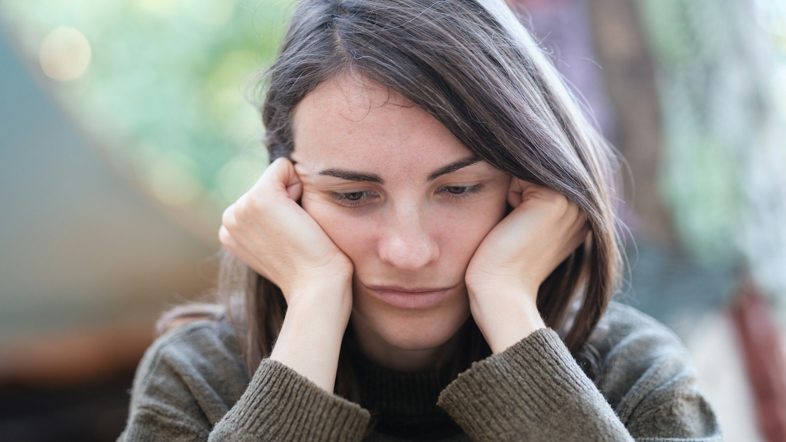 Woman holding her head in her hands