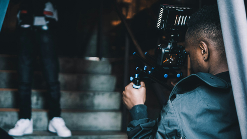 Filmmaker filming scene in stairwell