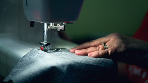 Person using sewing machine