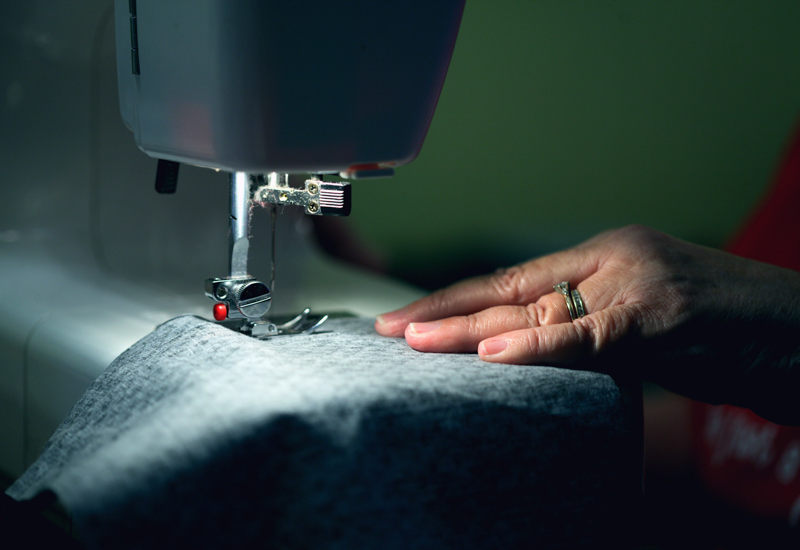 Person using sewing machine