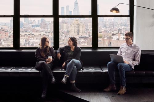 People in discussion on a couch.