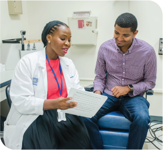 Image of an eye doctor showing information to a patient.