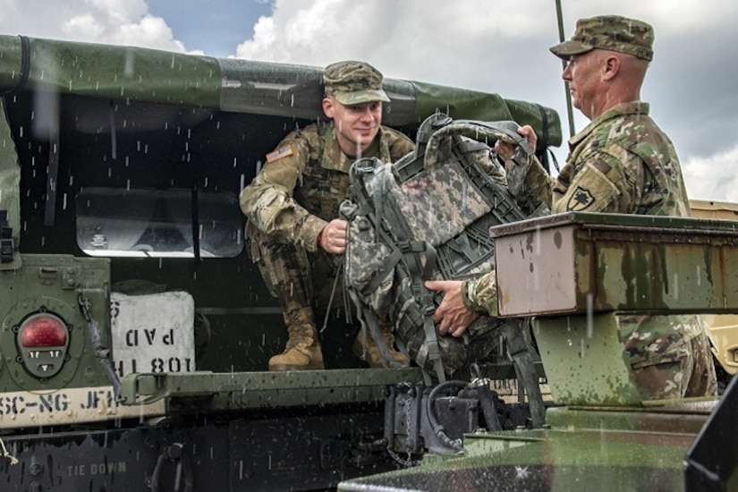 Military members unloading gear