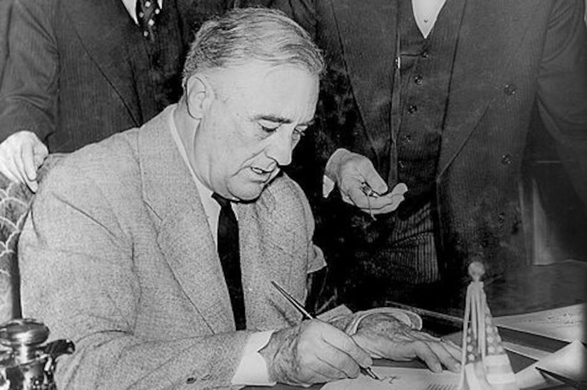 A man signs a paper.