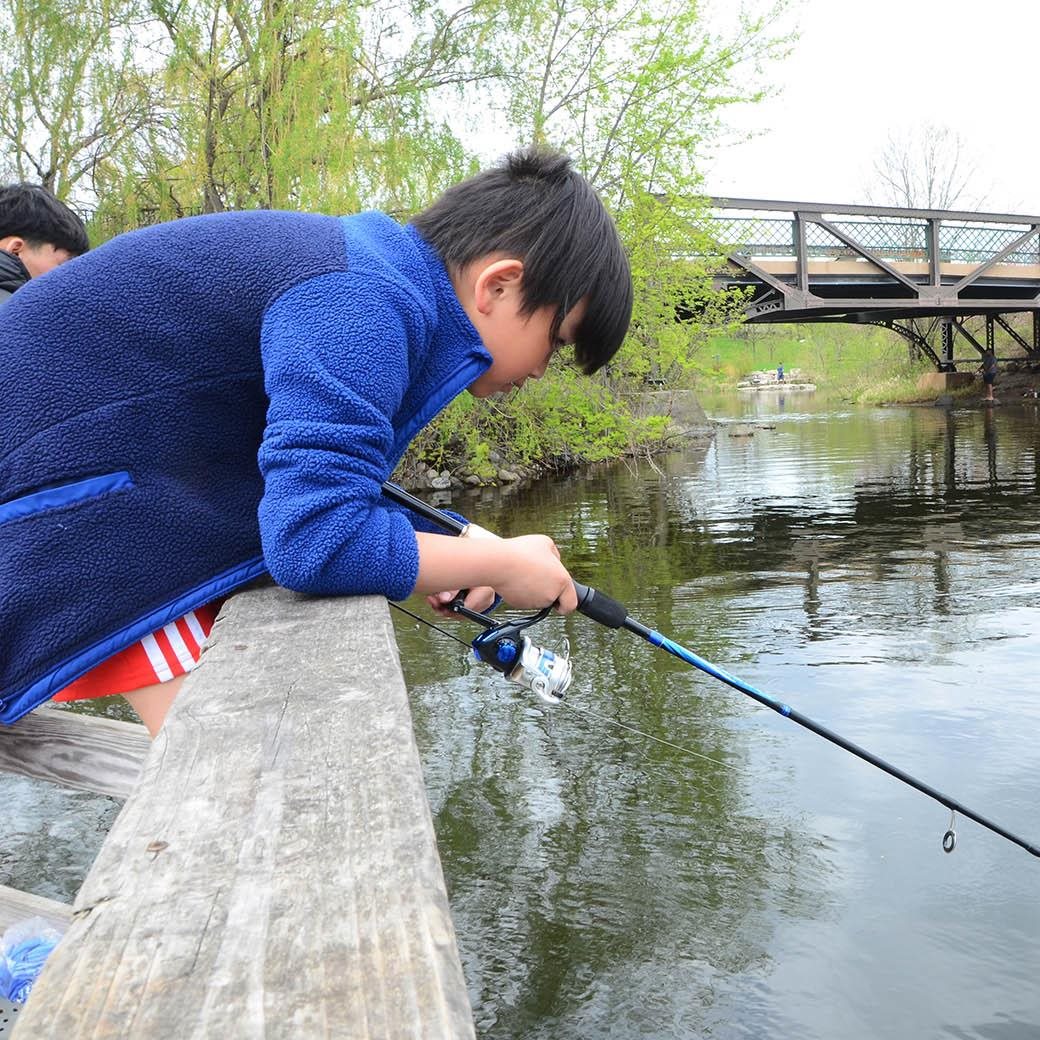 A boy fishing in a lake.