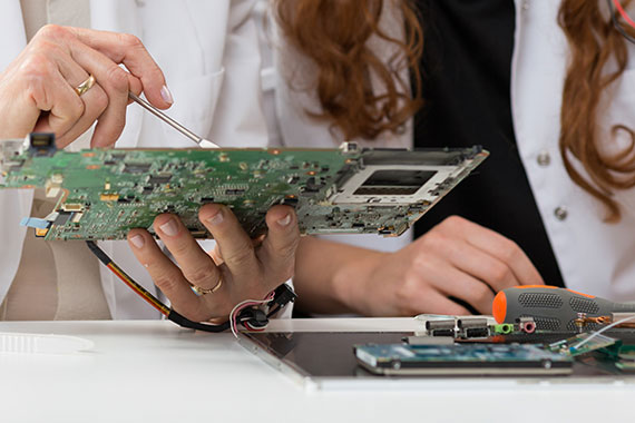 Hands working with a circuit board