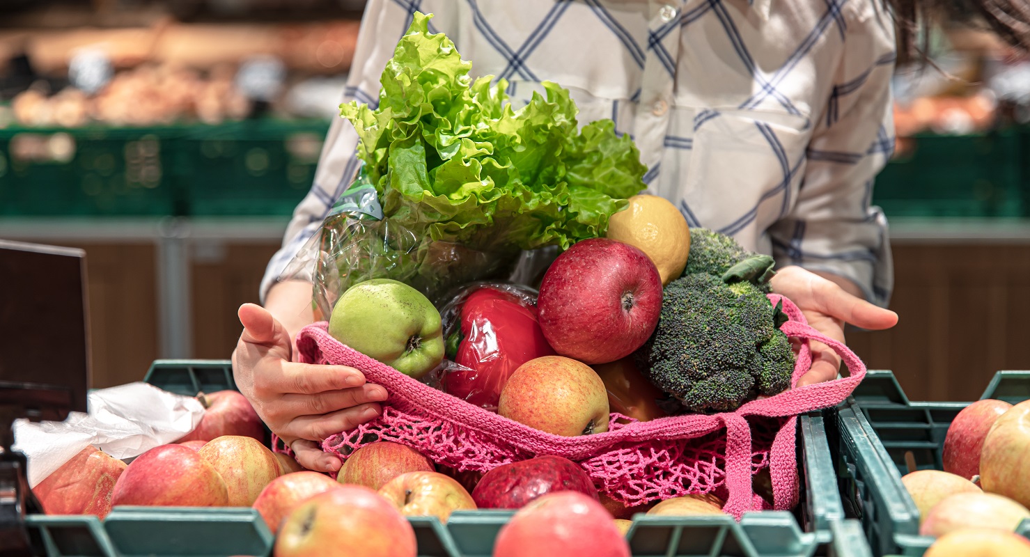 Close-up, fruits and vegetables in a shopping bag in a supermarket.