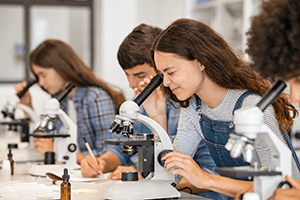 College Students Looking Through Microscopes