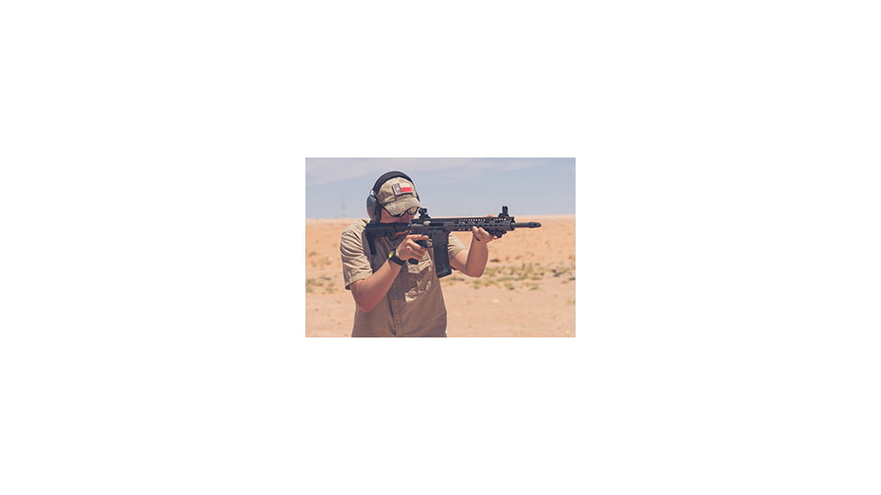 Man Shooting Rifle in Desert