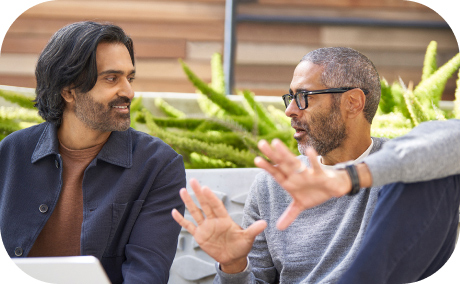 Two people conversing in an outdoor workspace