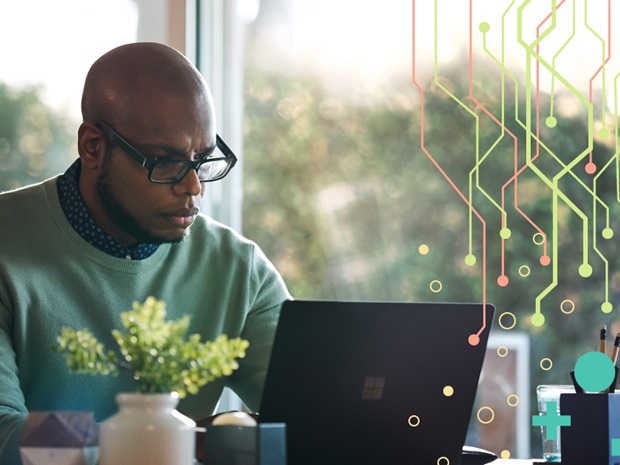 Photo of man using laptop with graphic overlay of circuitry design