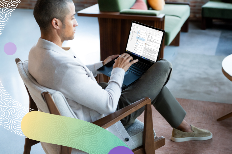 A person sitting on a chair with a laptop