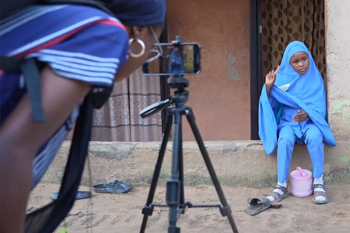 Filmmaker Aimalohi Ojeamiren films the young Salma for their mini-documentary.