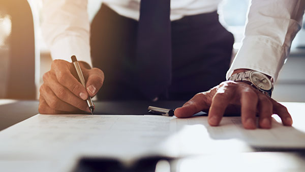 Man signing paperwork