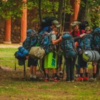 boys praying before their wilderness trip