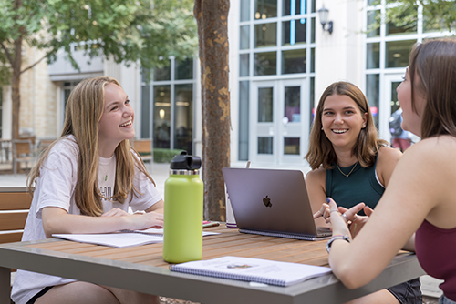 Students at outdoor patio table