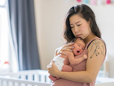 sad mom holding baby