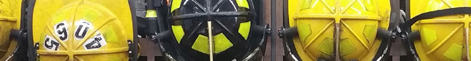 Firefighters’ helmets and jackets hanging in a line