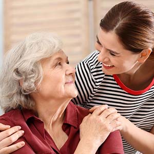 A younger woman taking care of an older woman