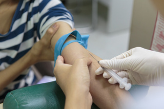 A nurse at Siriraj Hospital in Bangkok takes a blood sample from a pregnant woman. The blood will be screened for infectious disease including hepatitis B. Thailand has a rigorous screening program for pregnant women. Siriraj Hospital, Bangkok, Thailand. August 2019.