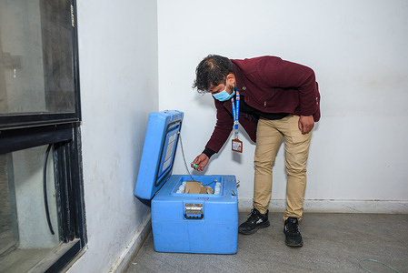 A frontline health worker examines the number of remaining Covid-19 vaccine at Bir Hospital, Kathmandu, Province Bagmati Pradesh.