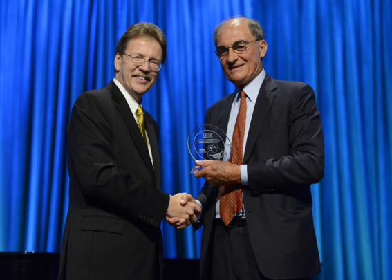 Dr. John E. Kelly, IBM’s Senior Vice President of Cognitive Solutions and Research, shakes hands with Vincent Mai, Chairman of the Board, Sesame Workshop.