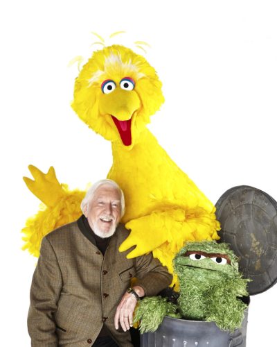 Caroll Spinney poses next to Big Bird and Oscar.