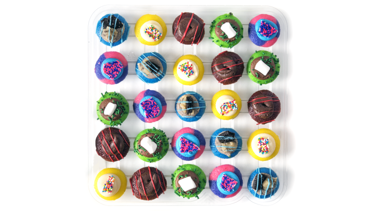 An overhead view of a tray of 25 colorful mini cupcakes, arranged to form a perfect square.