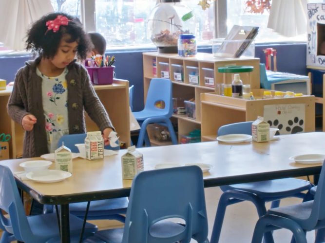 A child setting up her food at school.