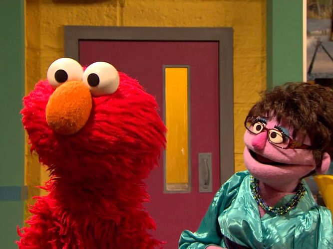 Elmo and a teacher.